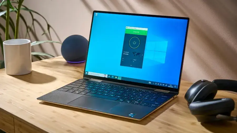 Laptop on a desk running a VPN app while connected to a wireless network